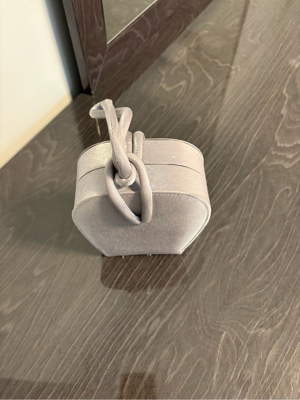 Light grey evening bag with top handle or rope strap